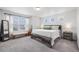 A bright main bedroom with large windows and neutral decor at 20000 E 40Th Ave # 4, Denver, CO 80249