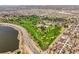 Scenic aerial view showcasing a neighborhood, golf course, highway, and distant city landscape at 4535 W 50Th Ave, Denver, CO 80212