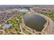 Aerial view featuring neighborhood lake with trails, tennis court, highway, and distant city views at 4535 W 50Th Ave, Denver, CO 80212