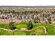 Aerial view of modern homes with golf course and greens in the distance at 4535 W 50Th Ave, Denver, CO 80212