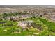 Aerial view showcasing golf course clubhouse and neighborhood, set among lush greenery at 4535 W 50Th Ave, Denver, CO 80212