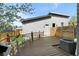 Inviting backyard deck with wood-look floors, a small grassy area, and contemporary design elements at 4535 W 50Th Ave, Denver, CO 80212