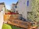 Cozy backyard features a deck, privacy fence, and a tree in bloom at 4535 W 50Th Ave, Denver, CO 80212