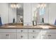 Bathroom with double sinks, framed mirrors, vanity, and tiled floors at 4535 W 50Th Ave, Denver, CO 80212