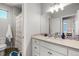 Bright bathroom featuring a white vanity, a sink with tile accents, and a shower with a patterned curtain at 4535 W 50Th Ave, Denver, CO 80212