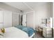 Bedroom featuring a four-poster bed, desk/vanity with storage, and dual closets at 4535 W 50Th Ave, Denver, CO 80212