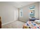 Neutrally painted bedroom with carpet and two windows provides a peaceful and bright space at 4535 W 50Th Ave, Denver, CO 80212