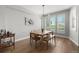 Bright dining area with a wooden table and bench seating, complemented by natural light from shuttered windows at 4535 W 50Th Ave, Denver, CO 80212
