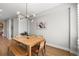 Contemporary dining room featuring a wooden table, mixed seating, and a stylish light fixture at 4535 W 50Th Ave, Denver, CO 80212