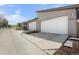 Modern home featuring an attached garage, gray siding, and concrete driveway leading to the entrance at 4535 W 50Th Ave, Denver, CO 80212