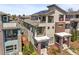 Rear exterior view of a modern home with solar panels on the roof, multiple balconies, and neat landscaping at 4535 W 50Th Ave, Denver, CO 80212