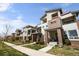 Modern townhome exterior with brick accents, stylish balconies, landscaping and sidewalk at 4535 W 50Th Ave, Denver, CO 80212