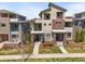 Beautiful, modern townhome featuring gray stucco and brick, plus balconies and landscaped front yards at 4535 W 50Th Ave, Denver, CO 80212