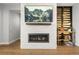 Modern fireplace with white brick surround and rustic wood accents, perfect for cozy evenings at 4535 W 50Th Ave, Denver, CO 80212