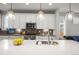 Close up of a modern kitchen featuring white cabinets, countertops, stainless steel appliances, and pendant lights at 4535 W 50Th Ave, Denver, CO 80212