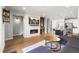 Spacious living room with a modern fireplace, TV, built in shelves, and an open view into the kitchen at 4535 W 50Th Ave, Denver, CO 80212