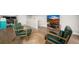 Cozy living area with mid-century modern chairs, round jute rug, and a mounted TV for a relaxing atmosphere at 4535 W 50Th Ave, Denver, CO 80212