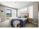 Bright main bedroom with large windows, neutral tones, a comfortable bed, and modern decor at 4535 W 50Th Ave, Denver, CO 80212