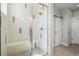 Contemporary walk-in shower featuring sleek glass doors, a built-in bench, and modern fixtures at 4535 W 50Th Ave, Denver, CO 80212