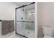 Clean and modern shower with gray tile and glass enclosure at 8074 S Quince Way, Centennial, CO 80112