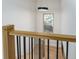 Modern staircase with light wood handrail and black balusters at 8074 S Quince Way, Centennial, CO 80112