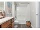 Clean bathroom with tub shower, toilet and wood vanity at 4538 Copeland Loop # 202, Highlands Ranch, CO 80126