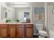 Bathroom with wood vanity, toilet, and bathtub at 4538 Copeland Loop # 202, Highlands Ranch, CO 80126