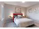 Bright bedroom with red headboard, ample lighting and window at 4538 Copeland Loop # 202, Highlands Ranch, CO 80126