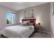 Bedroom with red accent wall, plenty of natural light, and a cozy atmosphere at 4538 Copeland Loop # 202, Highlands Ranch, CO 80126