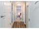 Bright hallway with wood-look flooring and doors to bedrooms at 4538 Copeland Loop # 202, Highlands Ranch, CO 80126