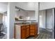 Kitchen counter with granite top, wood cabinets, and breakfast bar at 4538 Copeland Loop # 202, Highlands Ranch, CO 80126