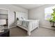 Bright bedroom features a window, a bed with blue accents, and neutral-toned walls and carpet at 6679 Kenzie Cir, Castle Pines, CO 80108