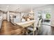 Open concept dining area with a rustic wooden table, adjacent to a modern kitchen at 6679 Kenzie Cir, Castle Pines, CO 80108