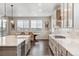 Bright kitchen featuring a large island, stainless steel appliances, and a dining area at 6679 Kenzie Cir, Castle Pines, CO 80108
