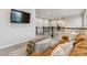 Cozy living room features a flat-screen TV, a round coffee table, and a comfortable leather sofa at 6679 Kenzie Cir, Castle Pines, CO 80108