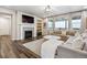 Cozy living room with a fireplace, large windows, and comfortable seating at 6679 Kenzie Cir, Castle Pines, CO 80108