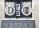 Stylish bathroom boasts double vanity sinks with white countertops and decorative round mirrors at 6679 Kenzie Cir, Castle Pines, CO 80108