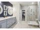 Modern main bathroom features a double vanity, a walk-in closet, and a glass enclosed shower at 6679 Kenzie Cir, Castle Pines, CO 80108