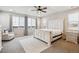 Bright main bedroom features a large window, ceiling fan, and a beautiful white wood bed frame at 6679 Kenzie Cir, Castle Pines, CO 80108