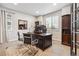 Inviting home office featuring a stylish wooden desk, comfortable chairs, and ample natural light at 6679 Kenzie Cir, Castle Pines, CO 80108