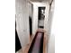 Bright hallway leading to a bathroom, showcasing the home's layout and design at 3626 S Granby Way # L03, Aurora, CO 80014