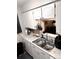 Close-up of the kitchen sink, countertop, and cabinets with modern fixtures and ample space at 3626 S Granby Way # L03, Aurora, CO 80014