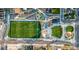 An aerial view displays a vibrant park with a soccer field, play area and tree lined walking spaces at 4341 N Columbine St, Denver, CO 80216