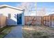 Fenced backyard with a patch of grass and a shed with a blue door, providing a private outdoor space at 4341 N Columbine St, Denver, CO 80216