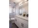 Bathroom featuring a double sink vanity, glass shower, and modern fixtures at 4341 N Columbine St, Denver, CO 80216