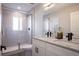 Bathroom with a double sink vanity, glass shower, and modern fixtures at 4341 N Columbine St, Denver, CO 80216