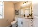 Clean powder room with white vanity and quartz countertop at 4341 N Columbine St, Denver, CO 80216