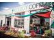 The exterior of Prodigy Coffee, a coffeehouse, is decorated with vibrant awning and outdoor seating at 4341 N Columbine St, Denver, CO 80216