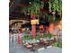 The interior of a commercial establishment is decorated with greenery and neon signs at 4341 N Columbine St, Denver, CO 80216