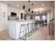 Modern kitchen with white cabinets, stainless steel appliances, and seating for six at the island at 4341 N Columbine St, Denver, CO 80216